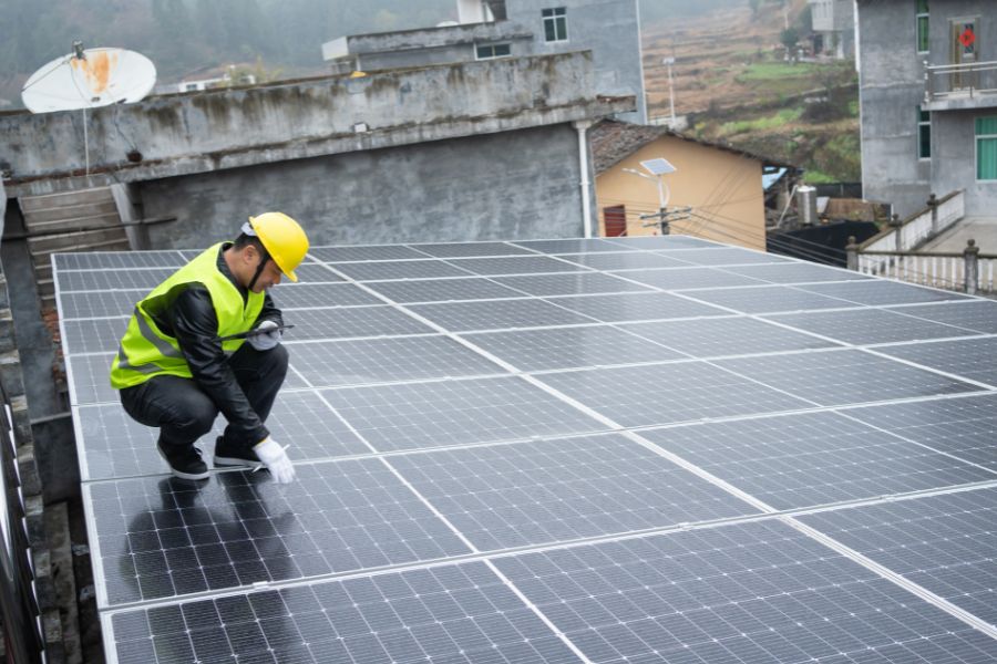 a man fixing solar panels